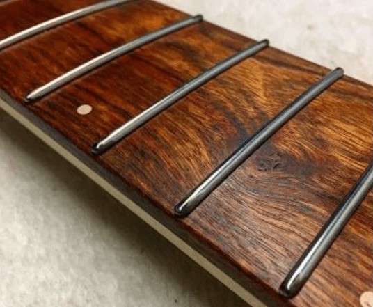 Frets on a brown fingerboard